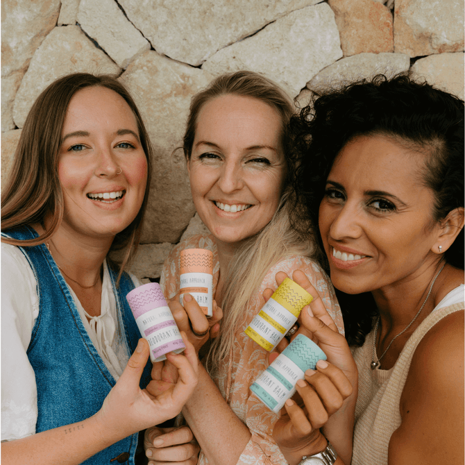 Three women holding eco-friendly deodorant push-up tubes in Natural Approach's sensitive skin range.